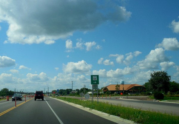 A car drives down a highway.