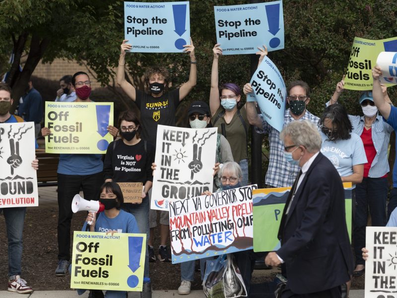 Demonstrators against the Mountain Valley Pipeline protest at Northern Virginia Community College, host of a debate between then-gubernatorial candidates Terry McAuliffe and Glenn Youngkin in September 2021.