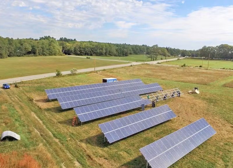 Solar panels in a grassy field.