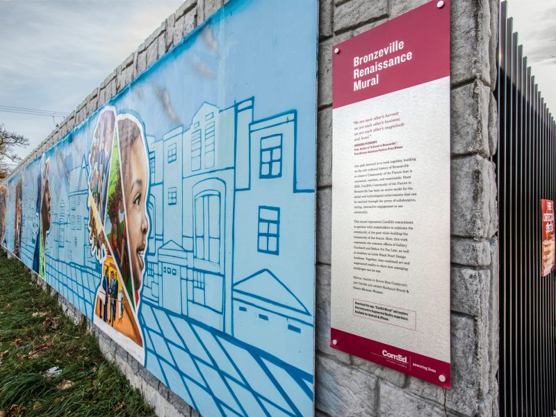 The right half of a mural features STEM-related themes, with a sign that identifies the artwork as the "Bronzeville Renaissance Mural"