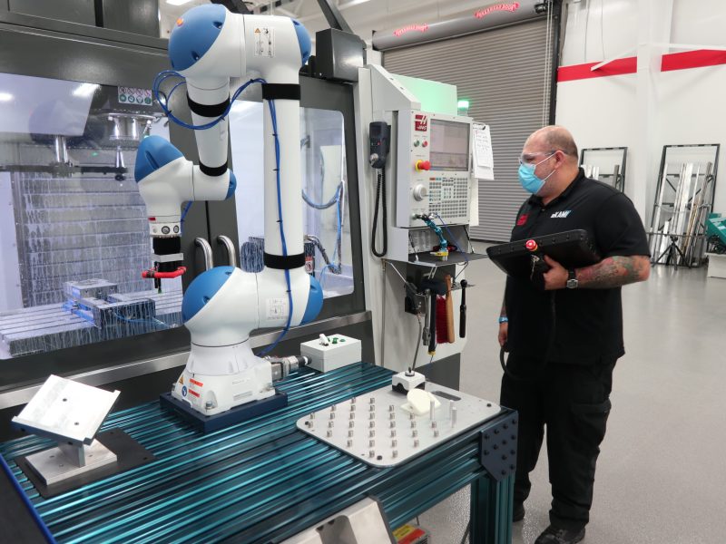 Mike Cepeda, an eKAMI instructor, with a state-of-the-art robot.