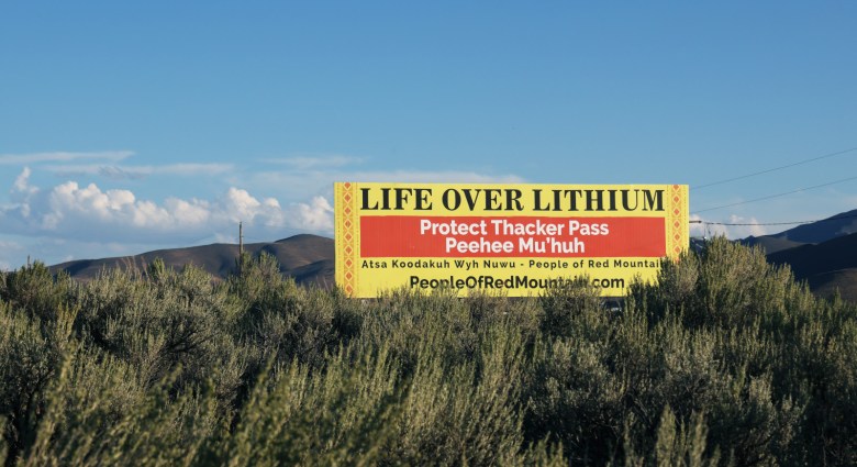 A billboard reading "Life Over Lithium, Protect Thacker Pass, People of Red Mountain"