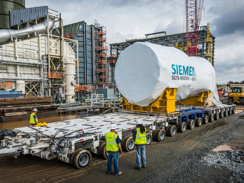 A natural gas turbine is delivered on a large, double-wide truck trailer to a Duke Energy power plant in North Carolina.