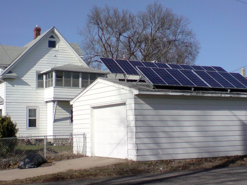 Solar panels on a detached garage behind an older home in Minneapolis.