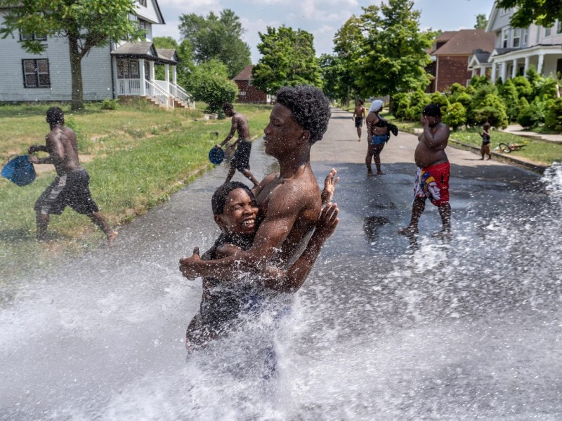 Kids playing in water hydrant